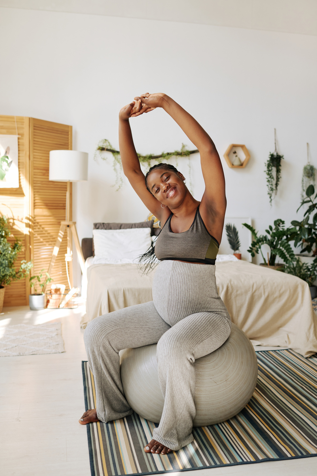 Pregnant Woman Exercising on Fitness Ball at Home